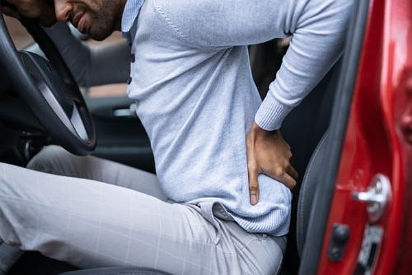 Driver with lower back pain after a car accident.