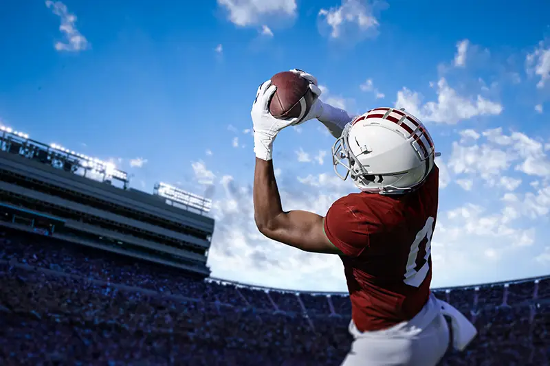 American football player catching the ball