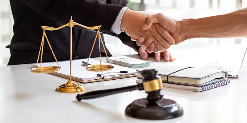 TBI lawyer shaking hand with client