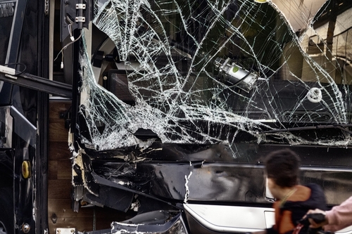 Busted bus window after an accident scene — Johns Creek bus accident lawyer helping injured victims recover compensation.