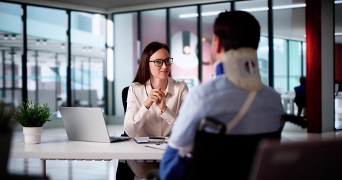 Female Johns Creek bus accident lawyer speaking with injured client about his bus accident claim and legal options. Contact 1Georgia personal injury lawyers to speak to a Johns Creek bus accident lawyer today.