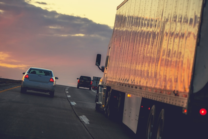 truck driving on the freeway at dusk