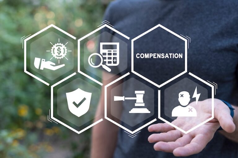 A person holds out an open hand supporting a holographic display of six hexagonal icons representing compensation- legal scales- financial calculations- insurance protection- injury- and monetary benefits illustrating the comprehensive coverage that workers' comp benefits provide to employees injured on the job in Georgia.