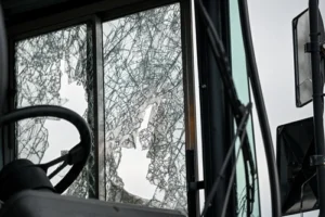 Shattered bus window after a serious crash in Atlanta symbolizing the devastation victims face before turning to an Atlanta bus accident lawyer for help.