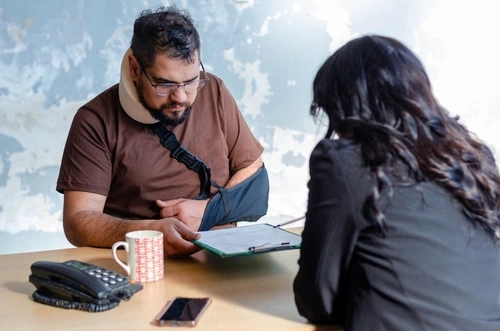 A lawyer explains to a client how a pre-existing condition affects a Georgia car accident settlement.