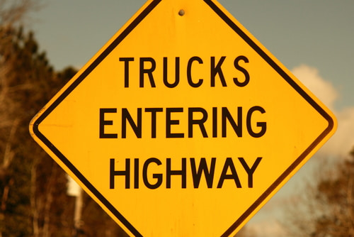 Yellow Trucks Entering Highway traffic sign