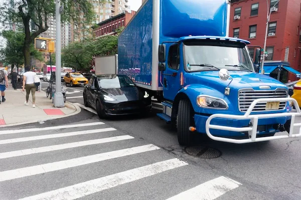 A blue truck ramming into the side of a car represents a Lawrenceville truck accident lawyer at 1Georgia Personal Injury Lawyers.
