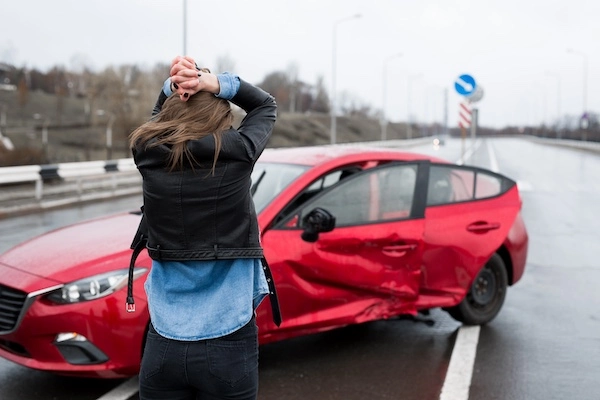 A distressed woman needs a car accident lawyer after her red car was hit in Sandy Springs.