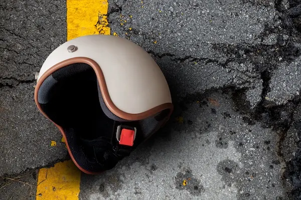 A motorcycle helmet lying on the road represents a Lawrenceville motorcycle accident lawyer.