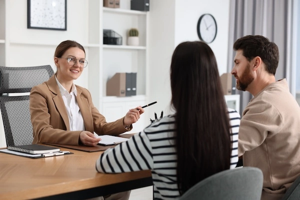 A pedestrian accident lawyer is speaking with two clients at 1Georgia Personal Injury Lawyers in Lawrenceville.