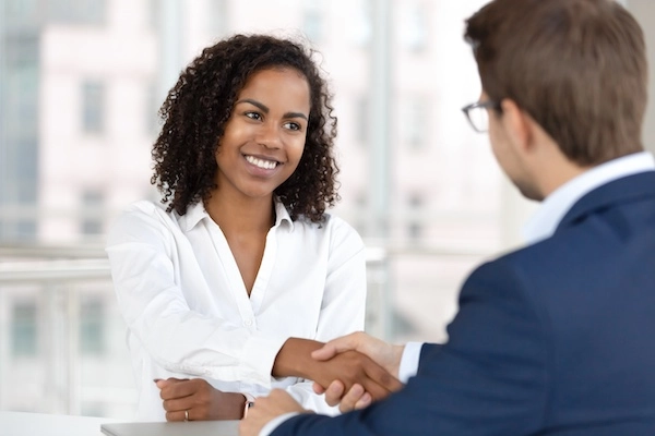 A Lawrenceville rideshare accident lawyer is shaking hands with a client at 1Georgia Personal Injury Lawyers.