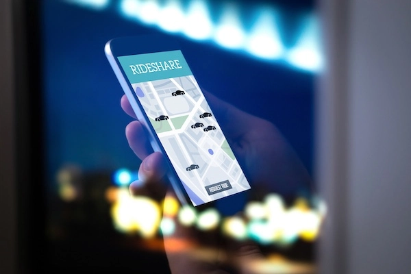 A person's phone displaying a rideshare app represents a Lawrenceville rideshare accident lawyer.